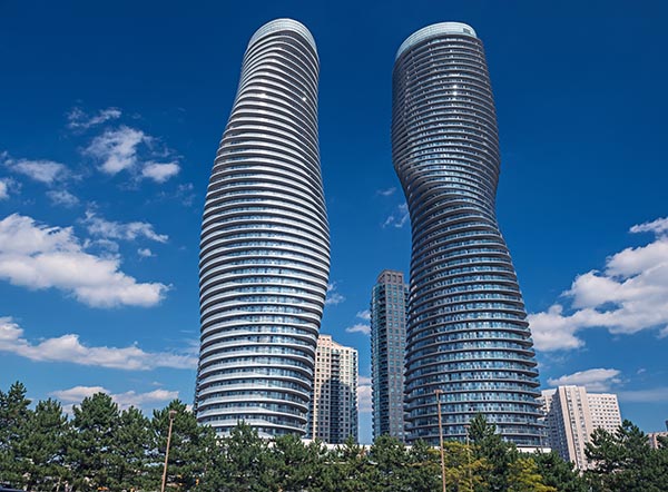 The Absolute World condominium Towers in the city center of Mississauga Ontario on a sunny afternoon. The hourglass shaped tower has been nicknamed the Marilyn Monroe tower due to the curvy shape.